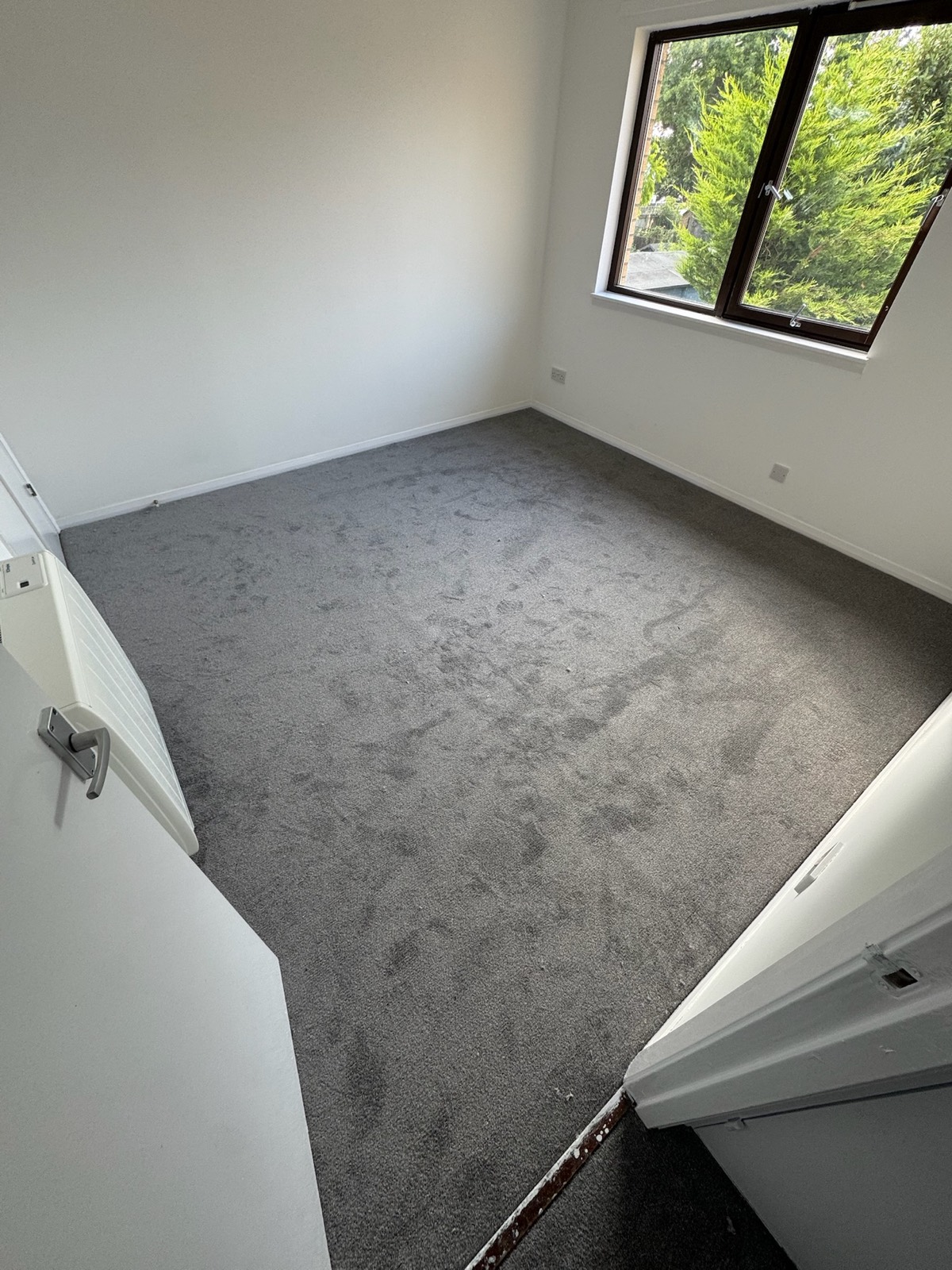 Apartment upstairs bedroom after carpet installation